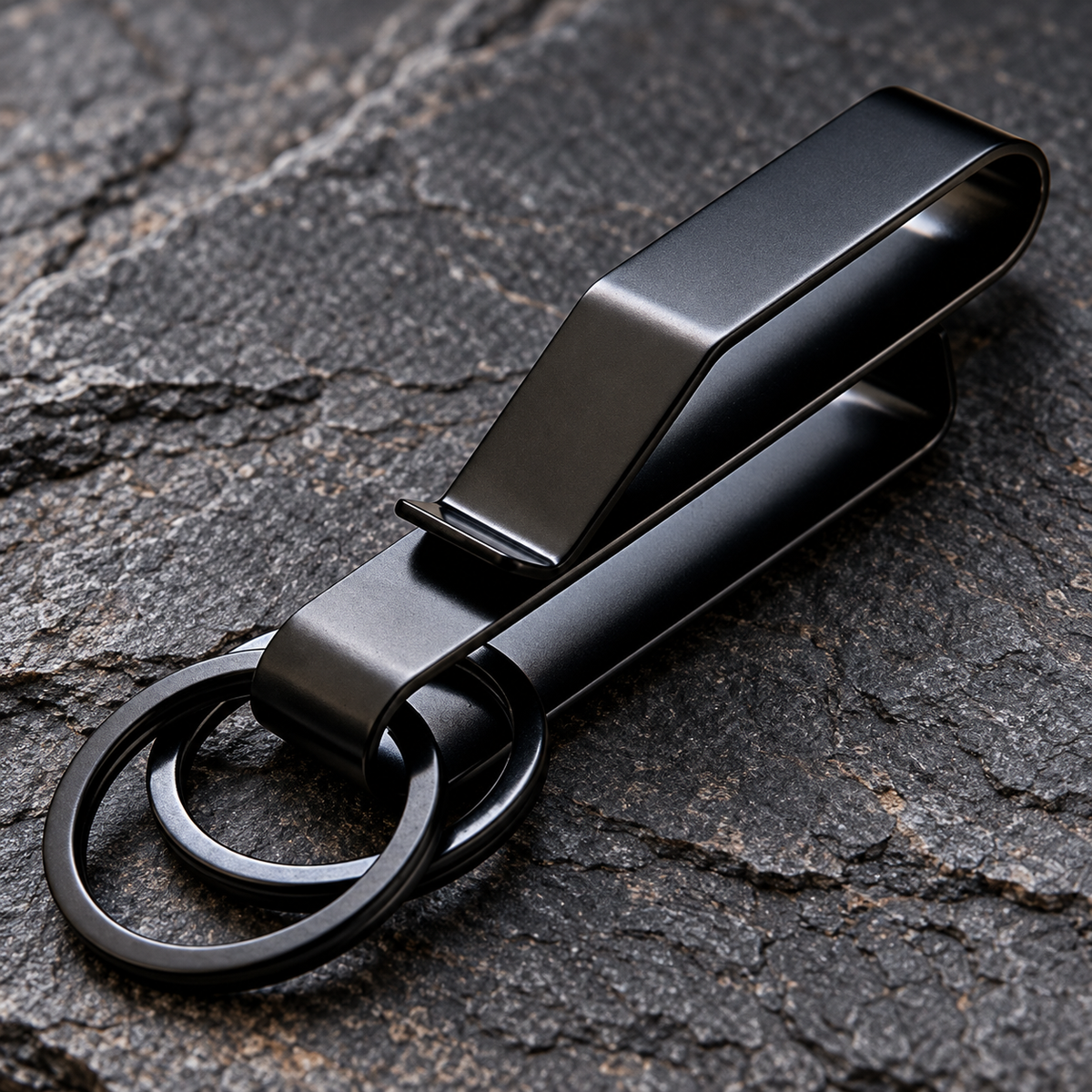 Side profile of the folded black Phantom stainless-steel belt clip and its two rings.