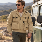 Adult man wearing the khaki Phantom Field Jacket outdoors beside a vehicle.