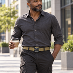 Adult man wearing the khaki Phantom quick-release belt with dark cargo pants during an urban commute.