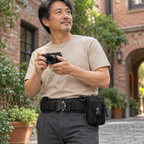 Adult man on a city photo walk wearing the black Phantom belt with one utility pouch.