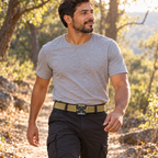 Adult man wearing the khaki Phantom woven belt on a light woodland walk.