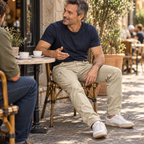 Phantom card city — Adult man talking with a friend at an outdoor cafe while wearing Phantom IX9 khaki pants.