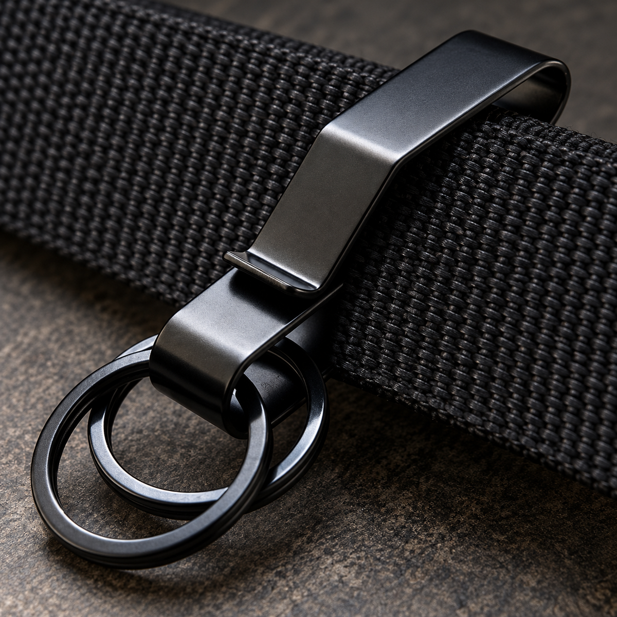 Black Phantom belt clip slipped over a plain woven belt.