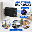 Adaptador negro con cámara, lente frontal y puerto USB, con rótulos en español.